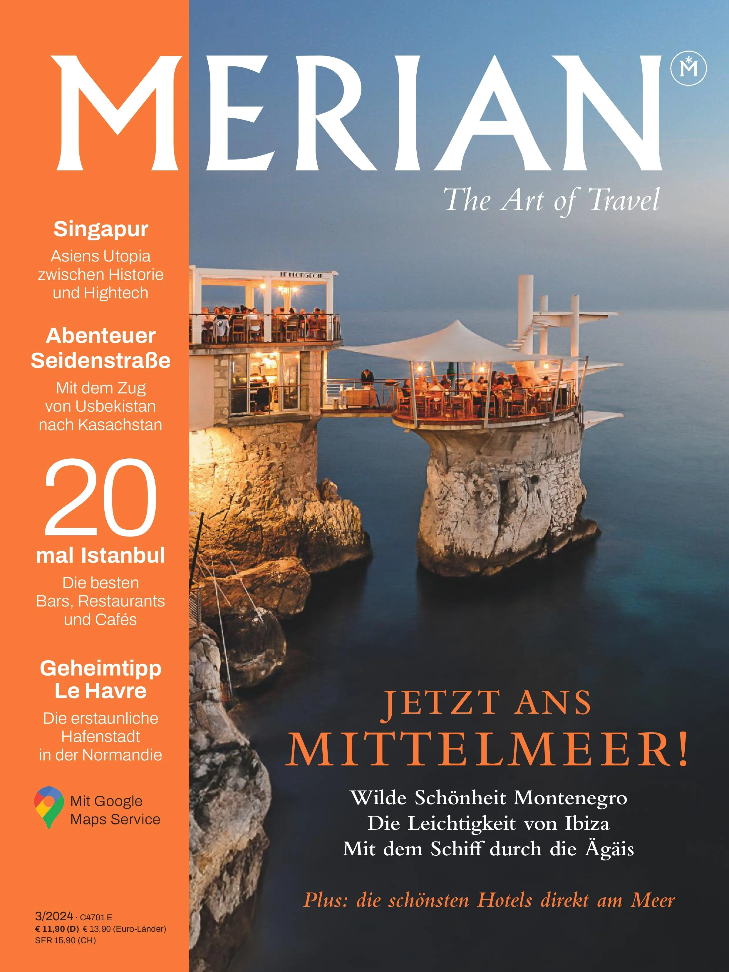 Cover of Merian travel magazine featuring a seaside restaurant built on two rock formations connected by a bridge, overlooking the ocean at sunset with restaurant lights on.