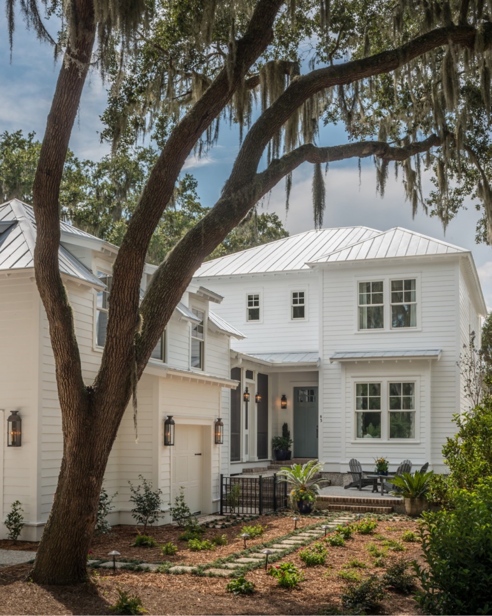   Deep eaves, exposed rafter tails, a metal roof for repelling heavy rains, and a tall live oak dripping with Spanish moss.  
