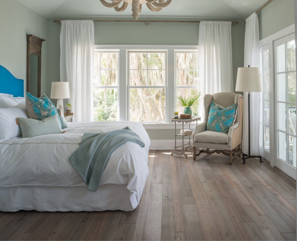  Soothing hues, softly weathered floors   and views of gauzy Spanish moss make the master bedroom a tranquil retreat.  