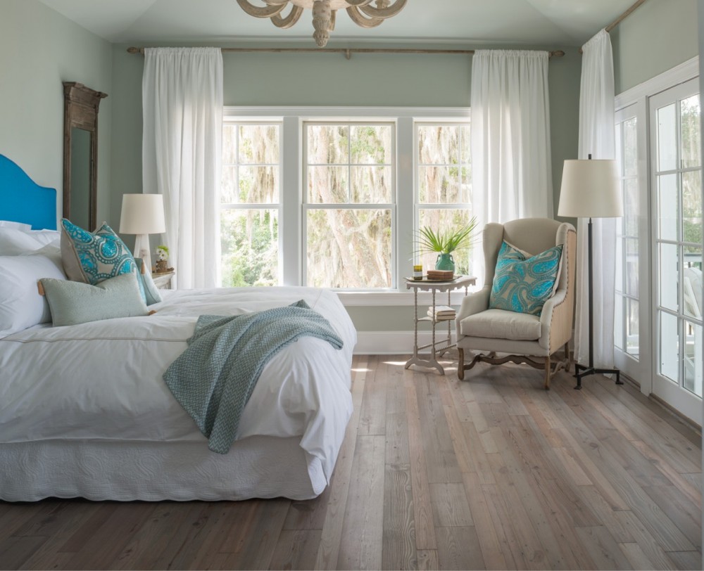 Soothing hues, softly weathered floors and views of gauzy Spanish moss make the master bedroom a tranquil retreat.