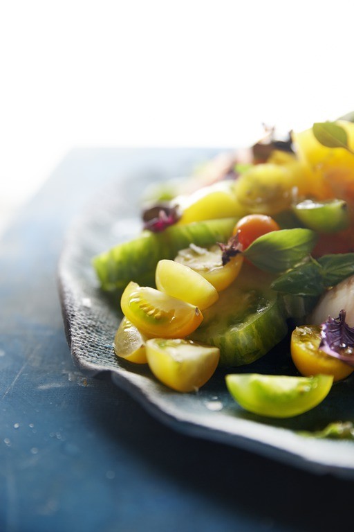   The art of food: Heirloom tomatoes add bright pops of complementary color to a true-blue kitchen.  