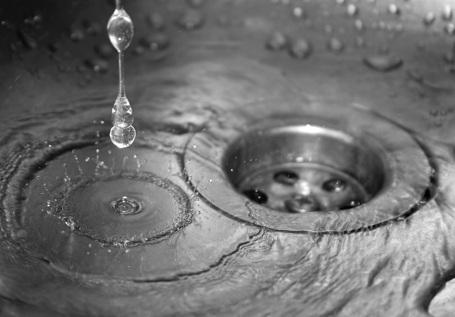 water-dripping-into-sink-and-down-plughole-closeup.jpg