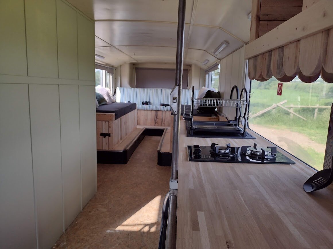 Stanford Farm's double decker bus conversion kitchen and lounge