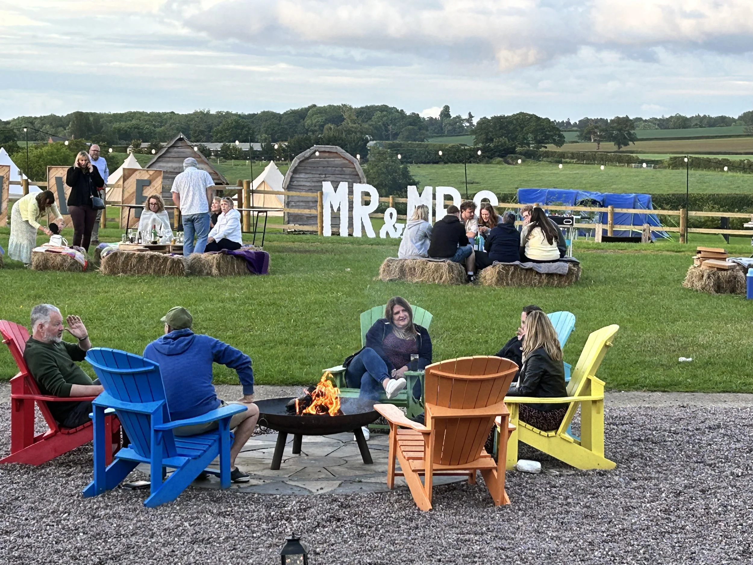 Relaxing on the Oval Green at Karen and Steve's 4 day Wedding at Stanford Farm in Shropshire 25th May 2024