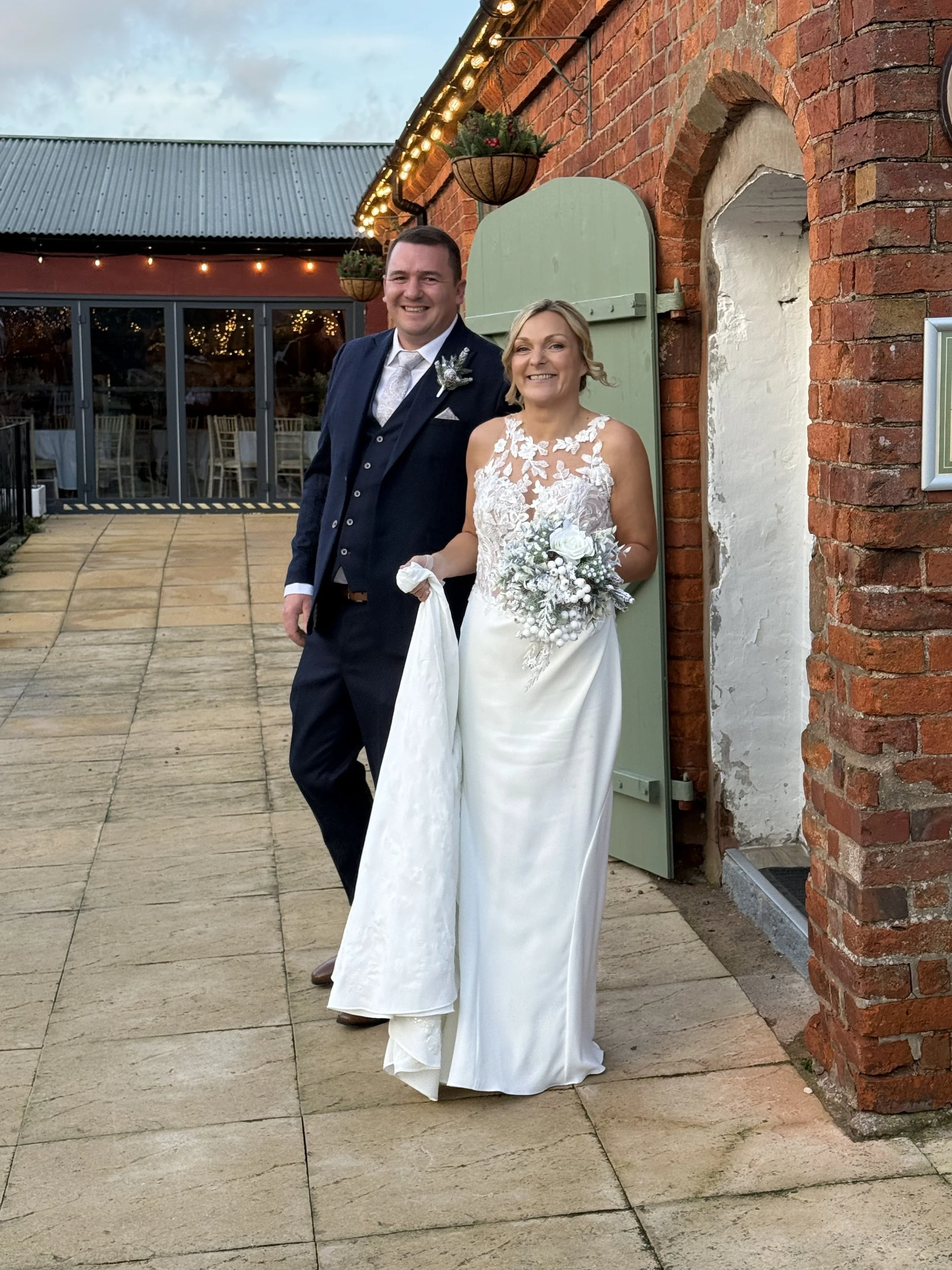 Jodie and Wayne outside the stables at their Winter Wedding at Stanford Farm 20th December 2025