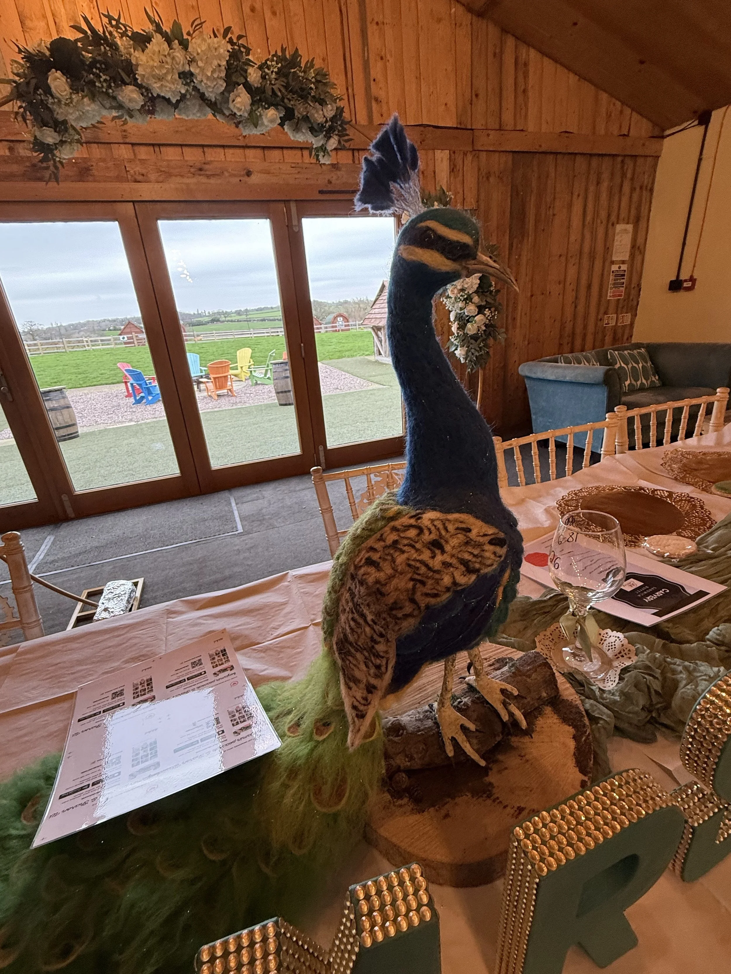 Peacock table decoration at Sharon and Ben’s wedding at Stanford Farm in Shropshire