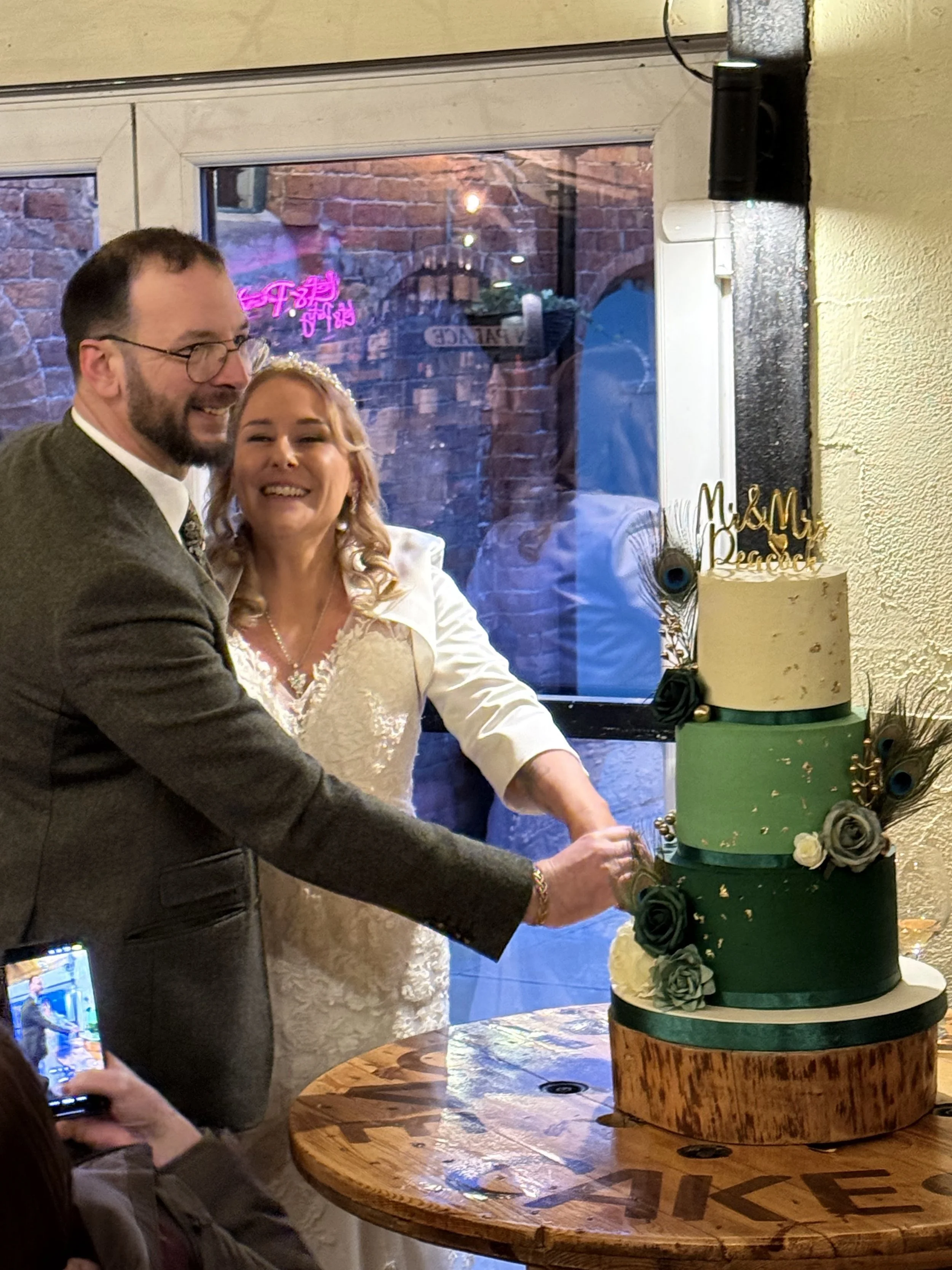 Sharon and Ben cutting the cake at their wedding at Stanford Farm in Shropshire