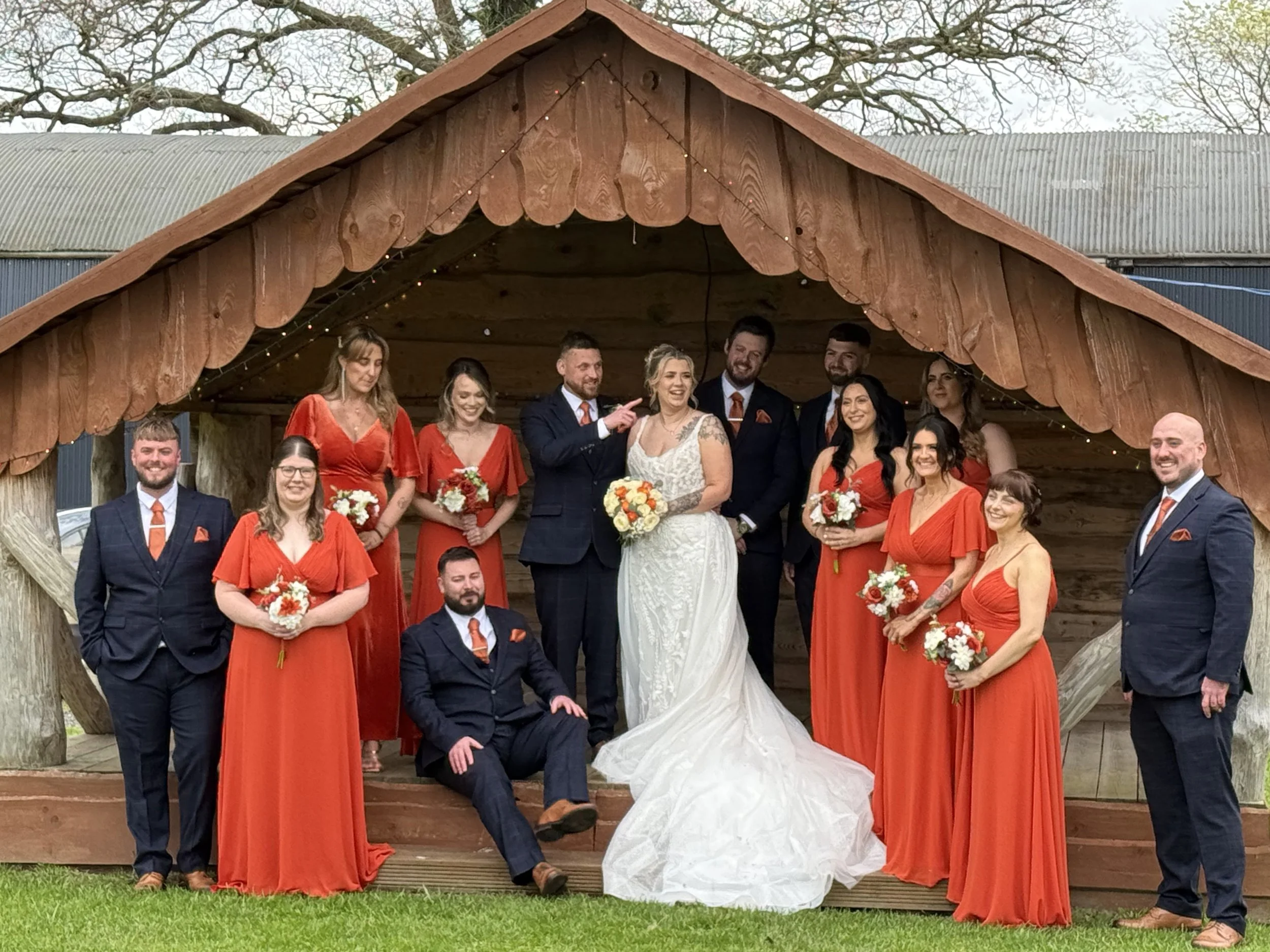 Katie and James's wedding party in the outdoor stage at their  wedding at Stanford Farm 1st April 2026