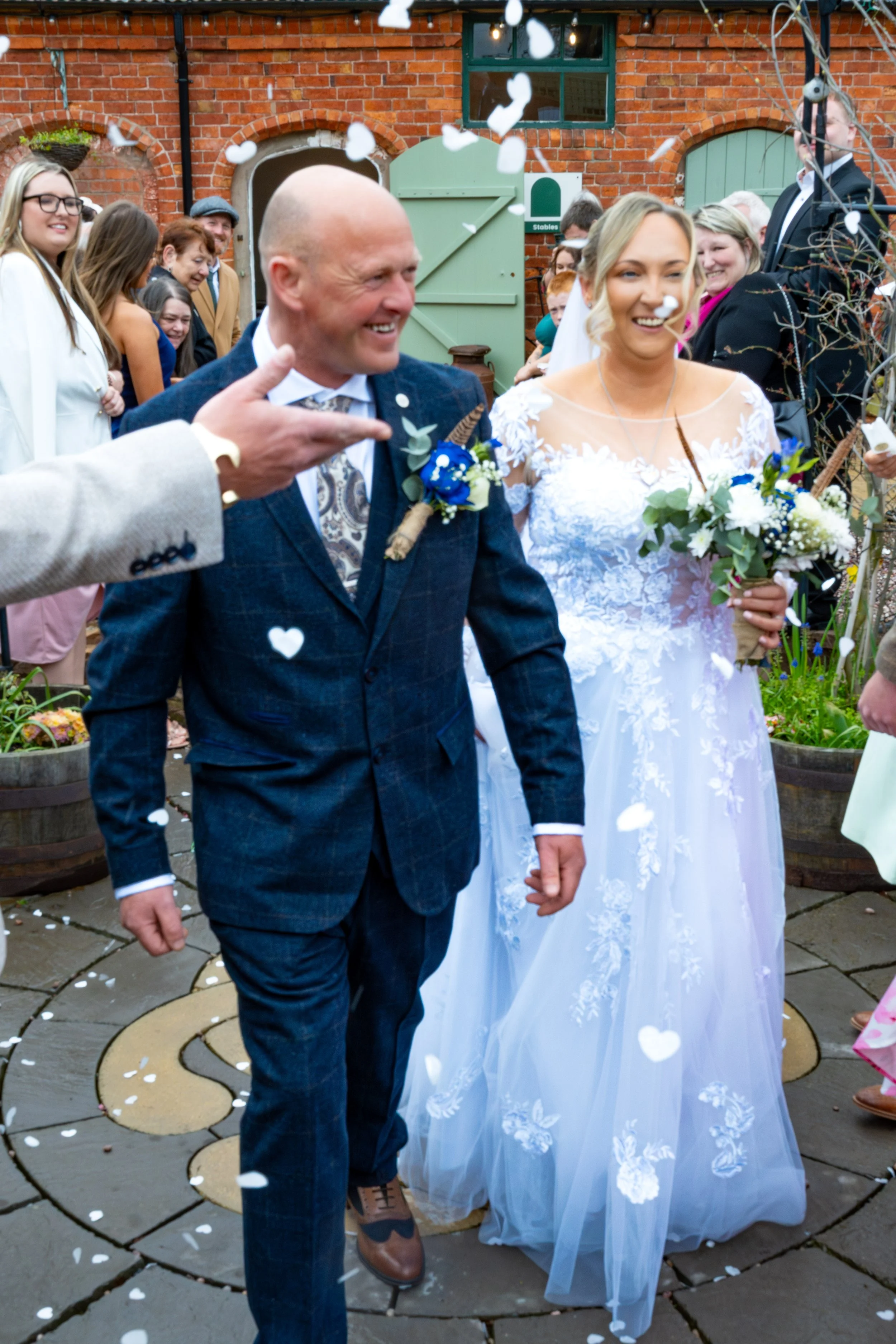 Confetti after the ceremony in the courtyard at Jodie and Phil’s Wedding at Stanford Farm, Shropshire