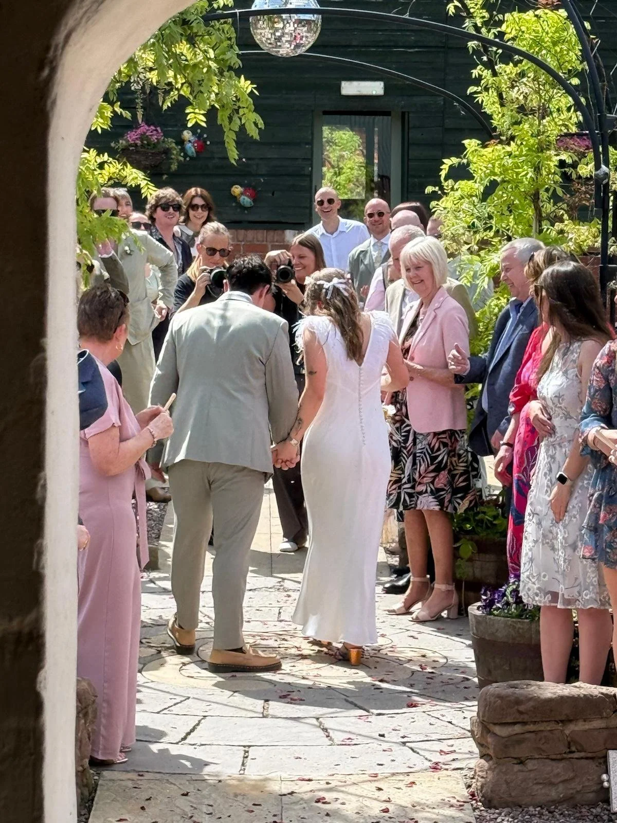 Exiting the Stables after the ceremony at Sarah and Carl's Bank Holiday Wedding at Stanford Farm, Shropshire