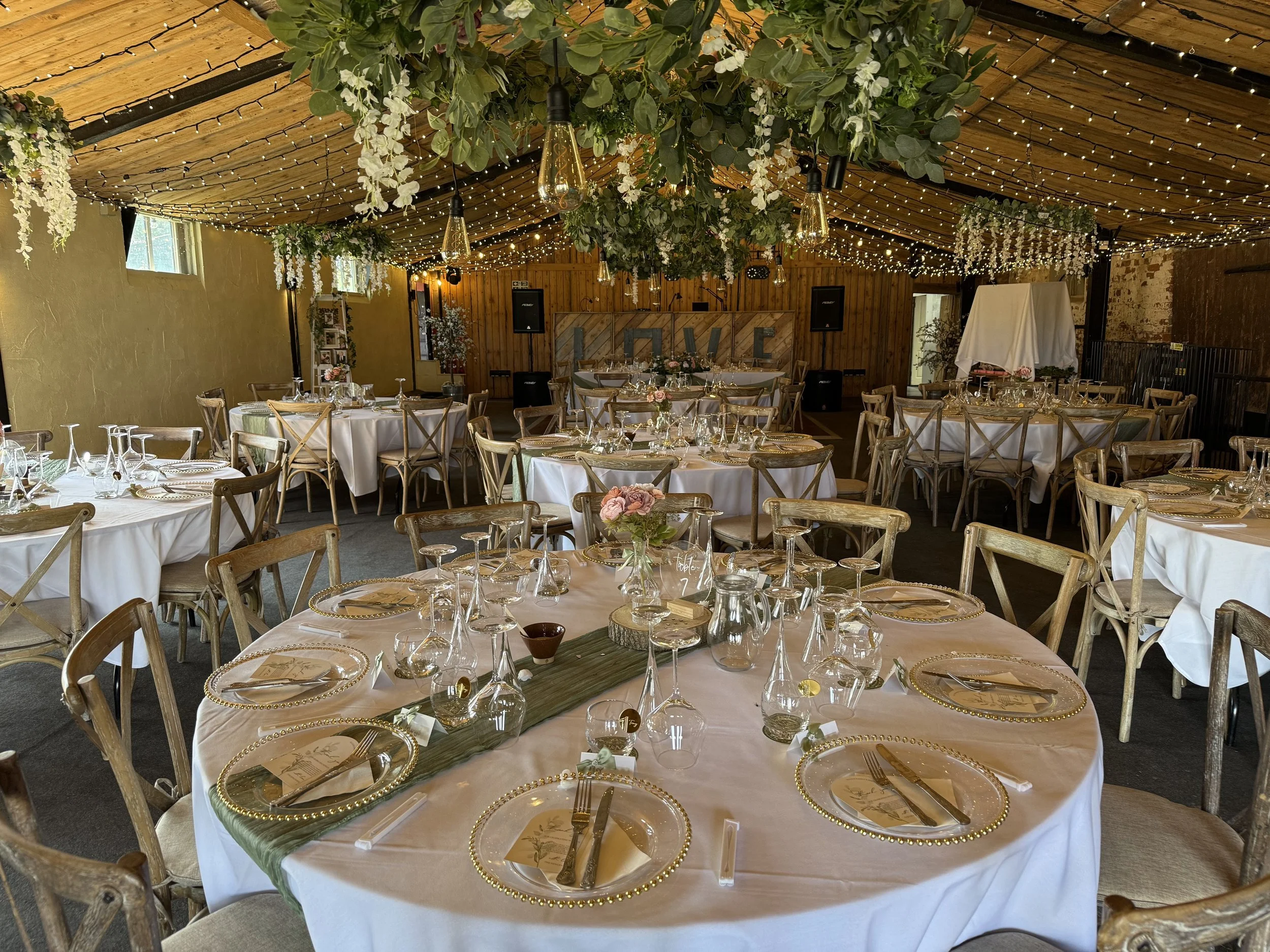 The cowhouse barn decorated in preparation for Emma and Steve’s Wedding reception at Stanford Farm