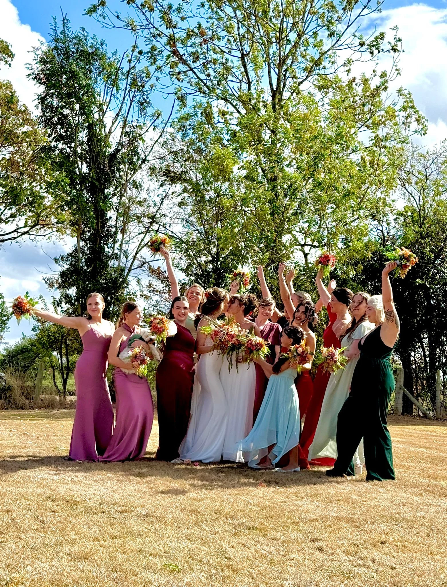 Celebrating in the Farmhouse garden at Kyla and Olivia's summer wedding at Stanford Farm