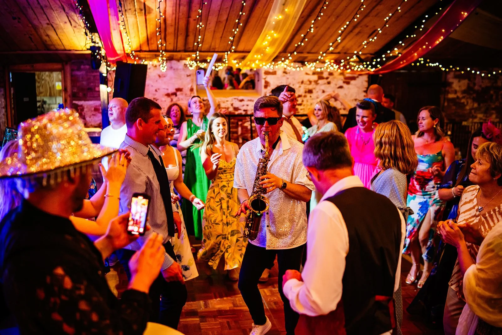 Late Availability weddings at Stanford Farm in Shropshire party in full swing with saxophonist in the Cowhouse barn
