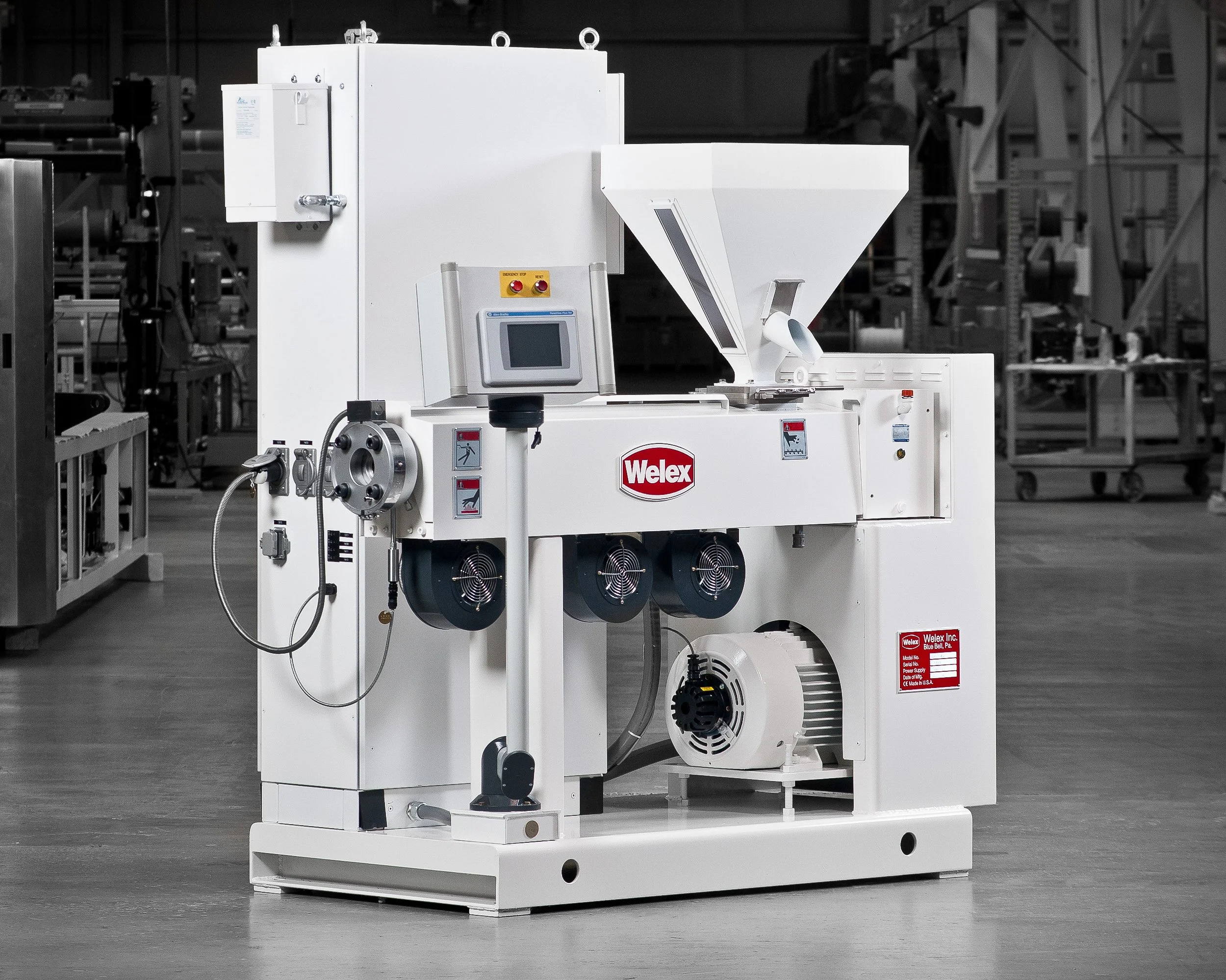 Industrial machine labeled 'Welex' in a factory setting with various controls and systems.