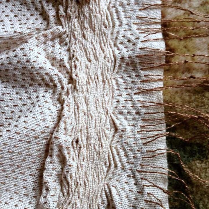 Brown pattern threads pulled out to create a border