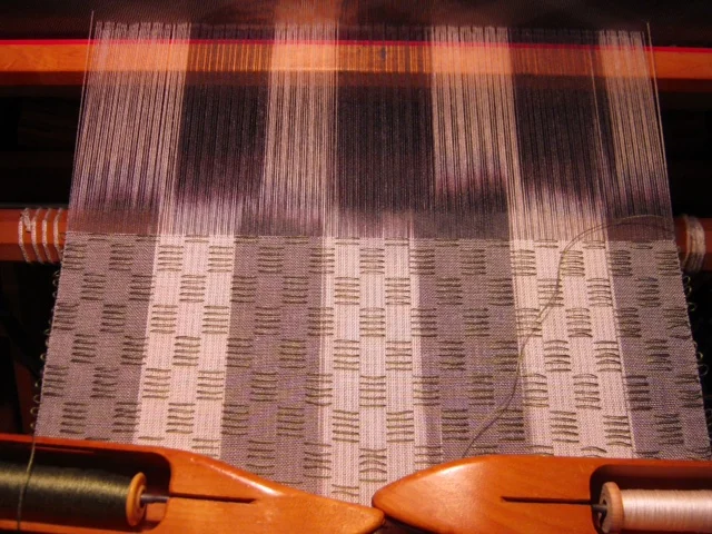Woven shibori scarf with painted warp on the loom.