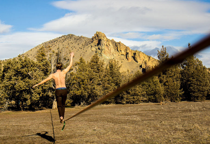 Jason Fautz walking the 170 ft longline at Smith Rock State Park.