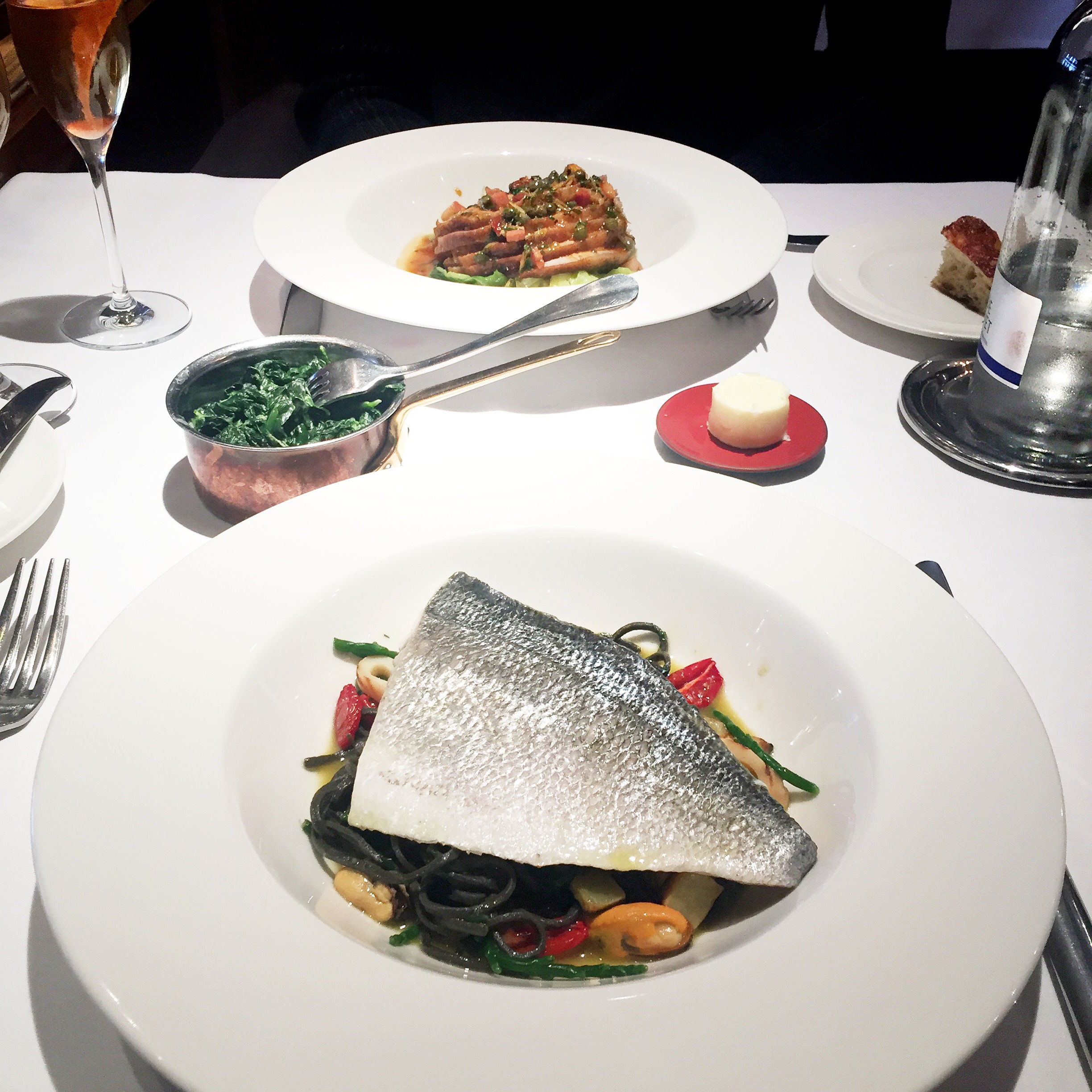 Mains: Slow Cooked Fillet of Sea Bream with Squid Ink Linguine & Mussel Casserole and Oven Roasted Iberico Pork Loin with Wilted Spring Cabbage, Bacon & Aromatic Roasting Jus.