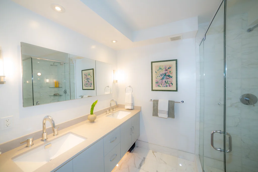 Designed by Marie Burgos Design - Photo Credit Francis Augustine Countertop: Clamshell by Caesarstone - Sperry Wall Sconces from Hudson Valley lighting. 
