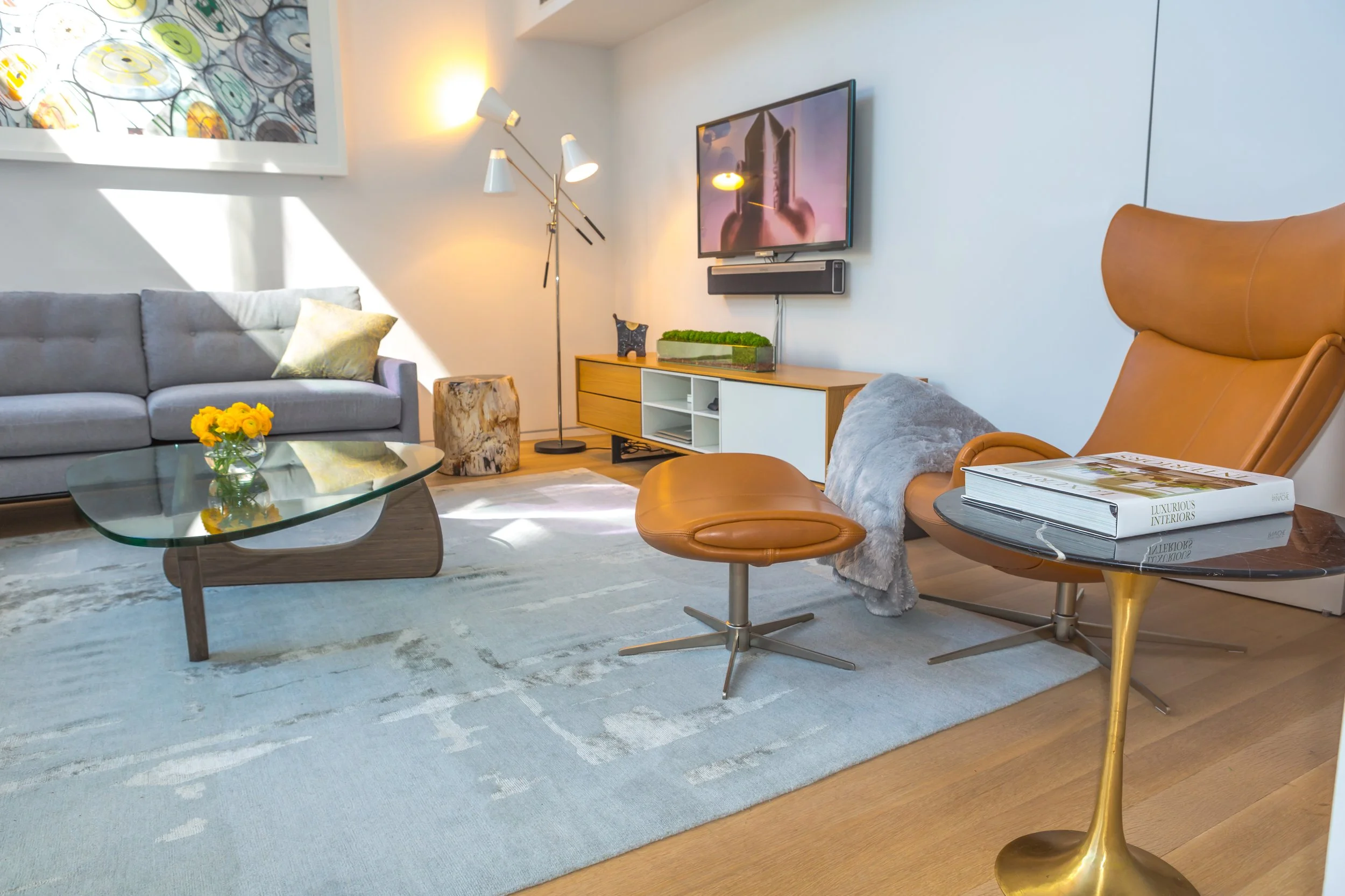 Vignette combining wood, brass, ceramic, glass and plant elements