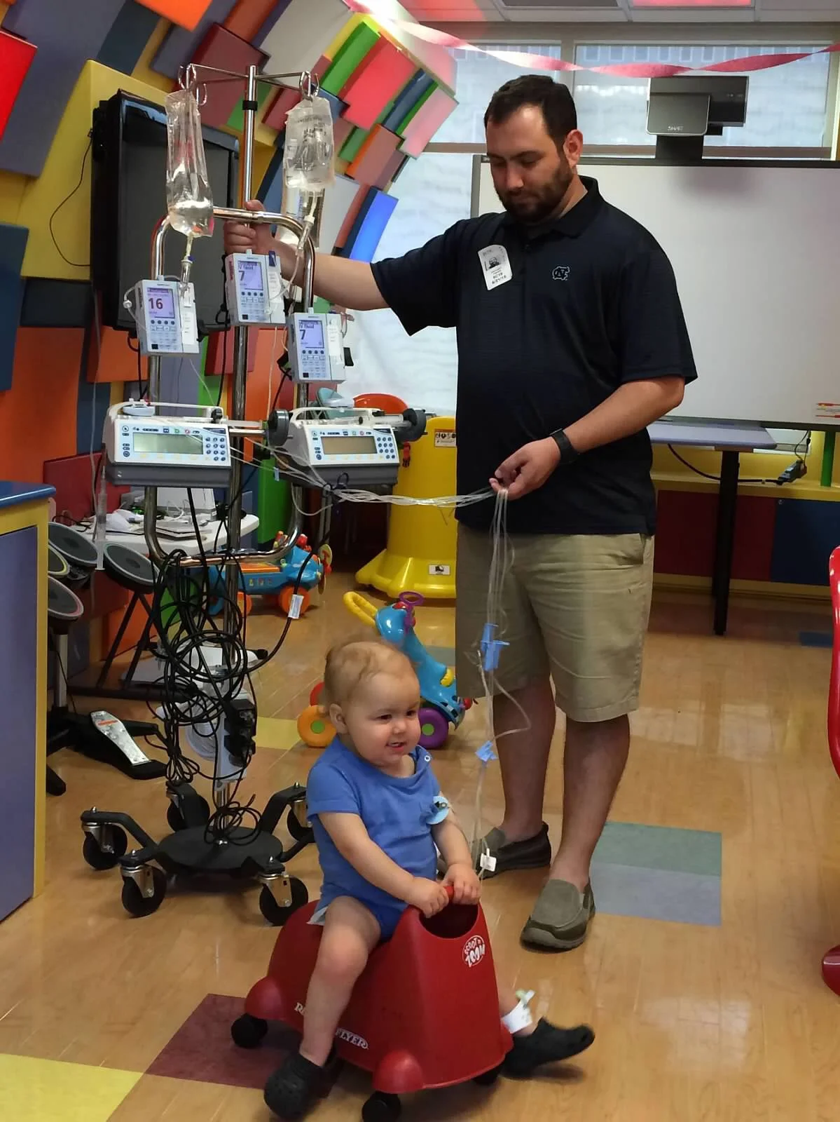 Still having fun in the Lion's Den at NC Children's Hospital, even with his quad IV pole and a blood infection post bone marrow transplant