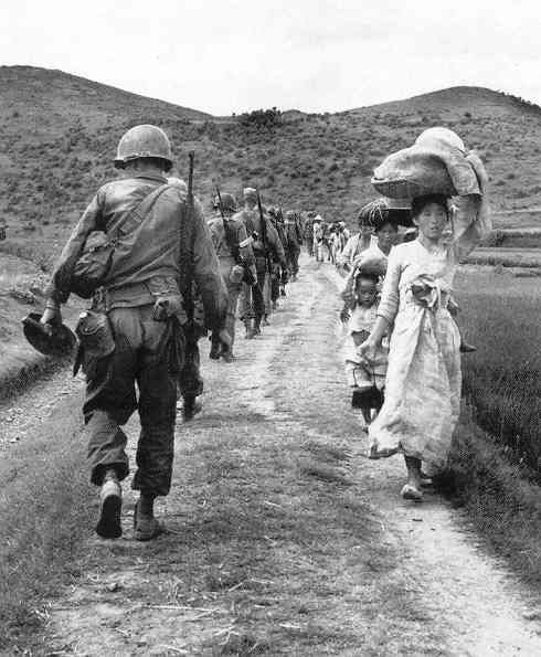  GI's advancing to the action; Koreans civilians fleeing the action, 1950 