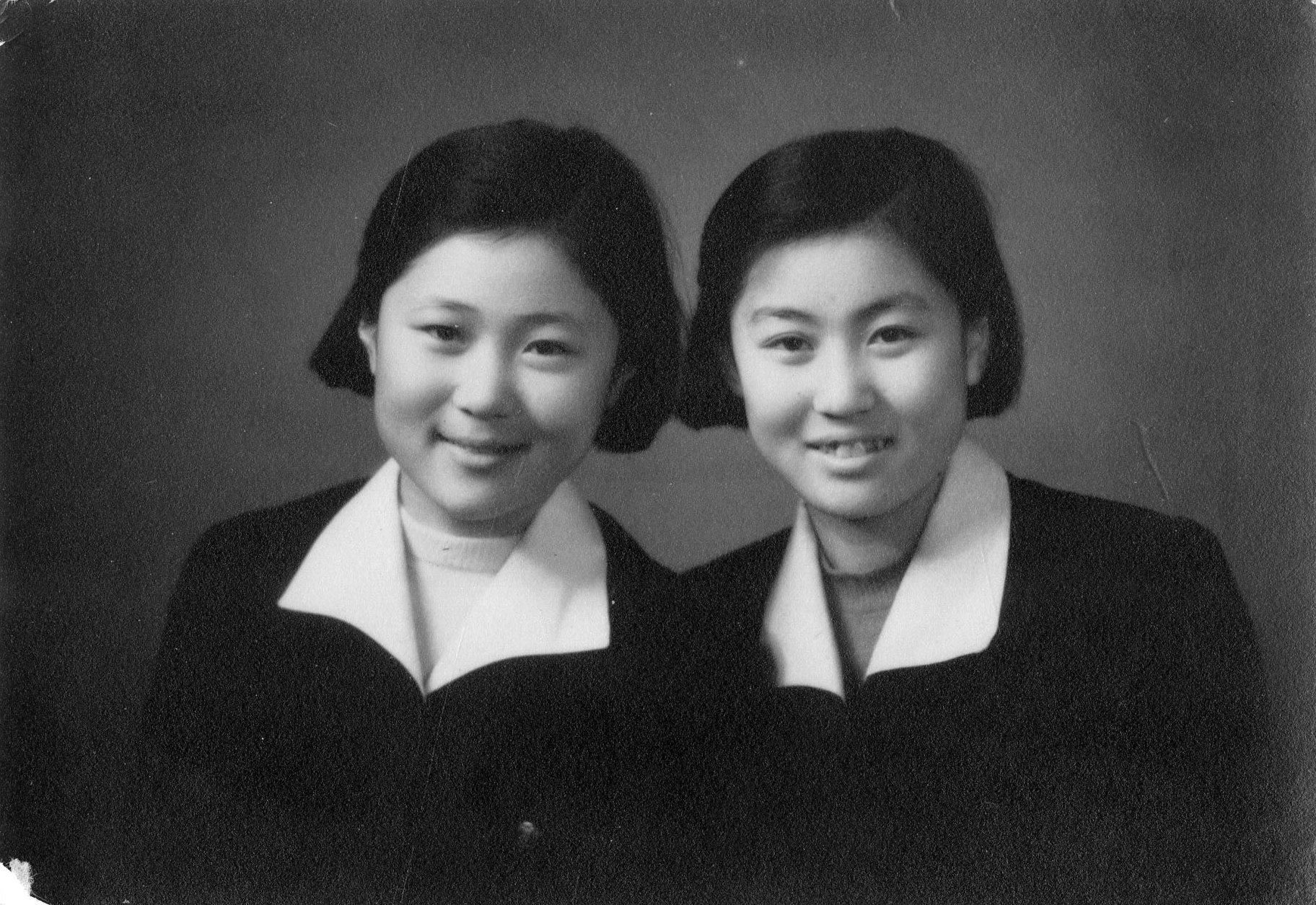 With her sister, in their school uniforms, 1950s