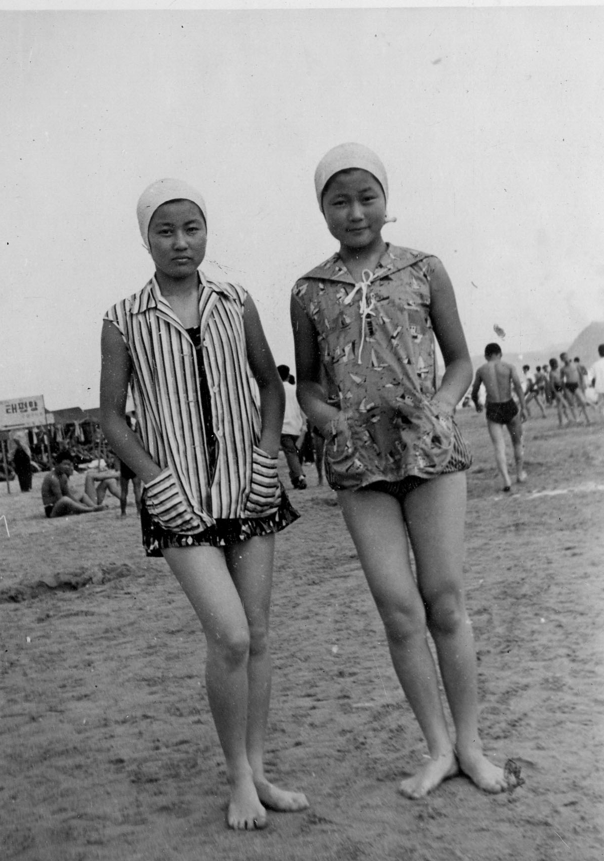 With her sister on the beach, late 1950s