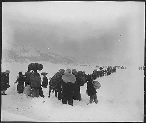  Korean refugees trudge through the snow and ice outside Kangning,&nbsp;1951 (Source: &nbsp;U.S. National Archives and Records Administration) 