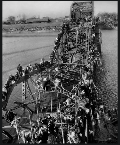 Refugees crossing a wrecked bridge (Source: &nbsp;AP Photo/Max Desfor) 