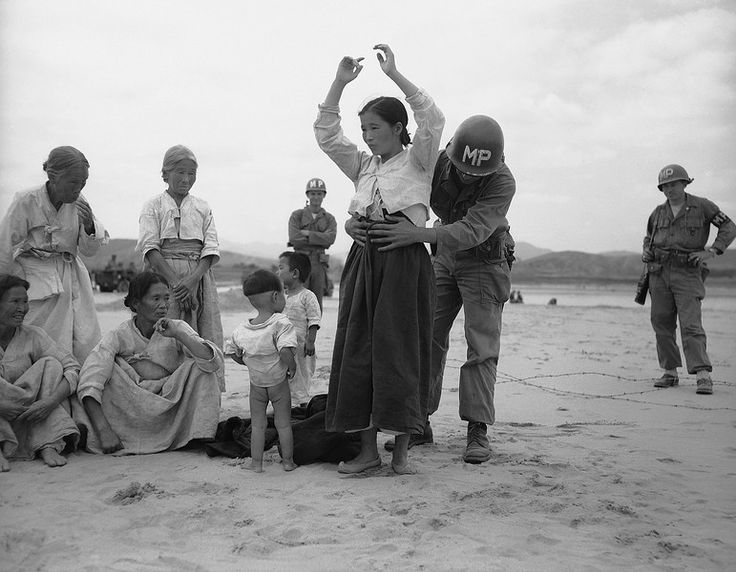  U.S.military searches Korean refugee for possible hidden weapons, 1950 (Source: &nbsp;AP Photo/Gene Herrick) 