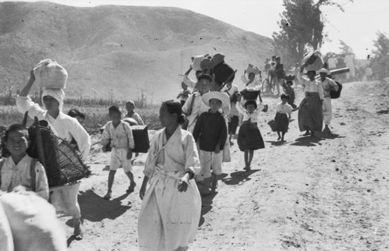  A stream of civilians flee their homes, carrying their possessions on their backs, 1950 (Source: &nbsp;Australian War Memorial) 