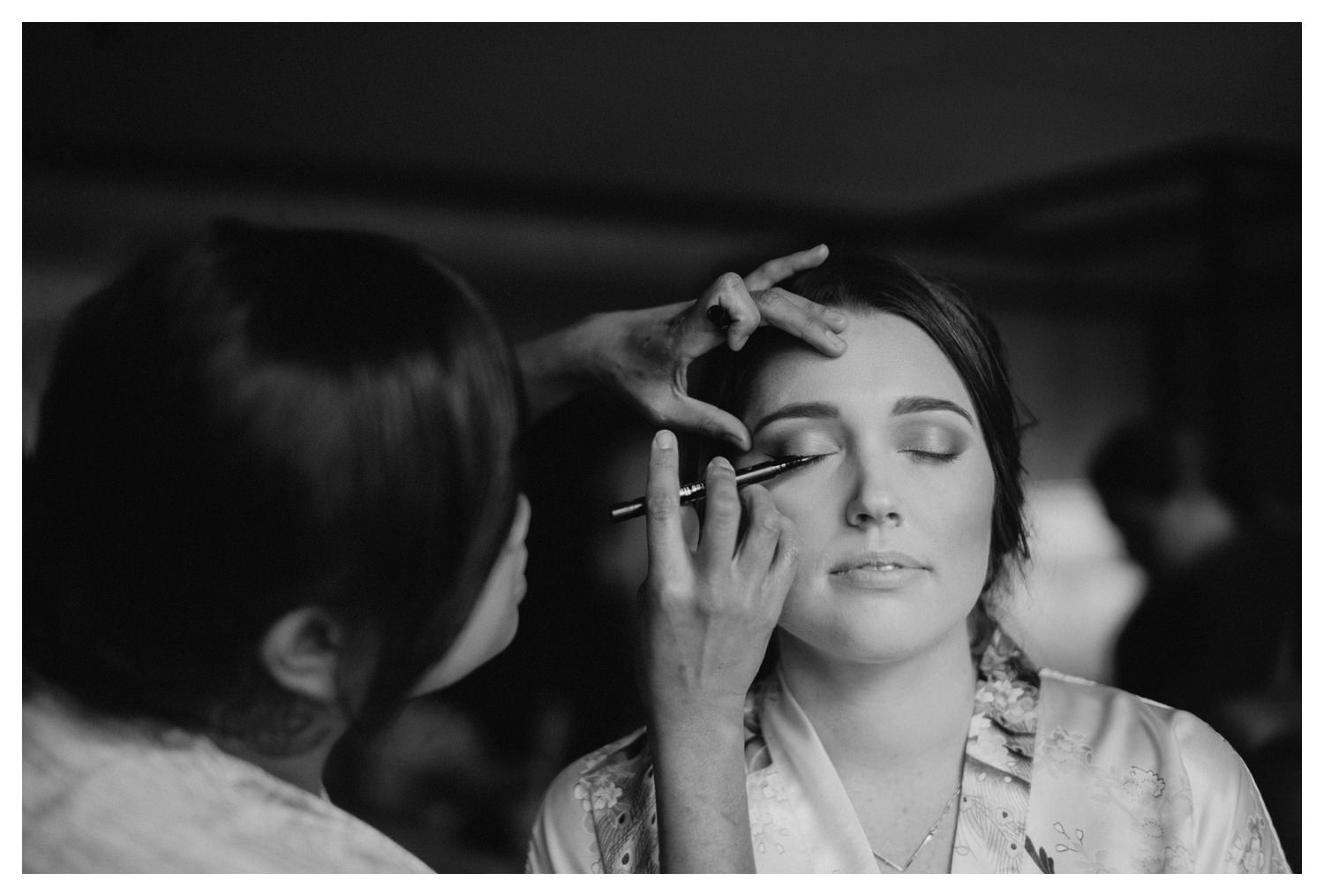 The bride has her make-up applied on her wedding day