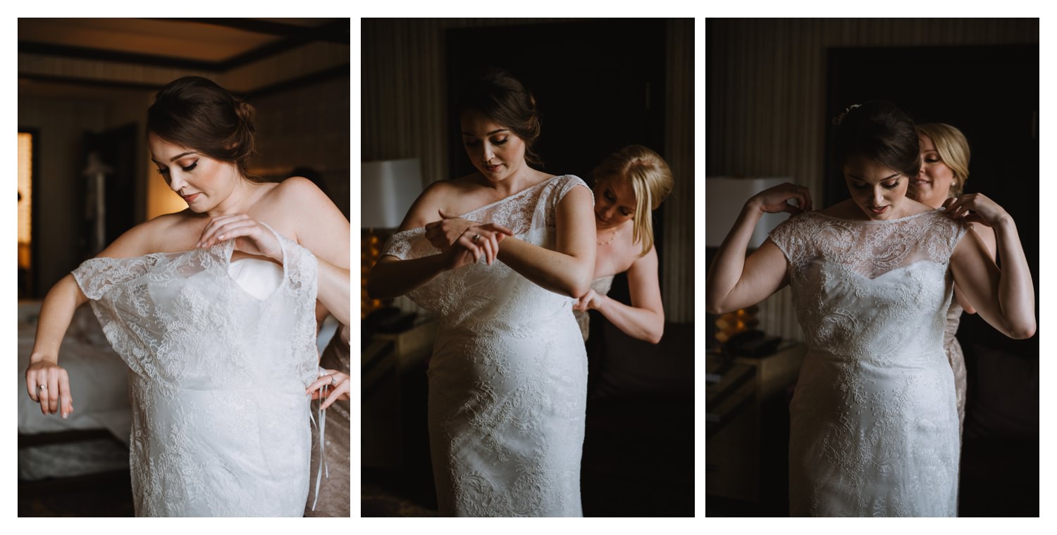 A beautiful bride is helped into her wedding dress