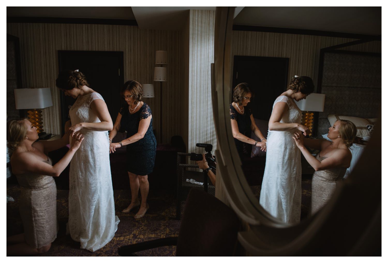 The reflection of a bride and her mother in a  mirror