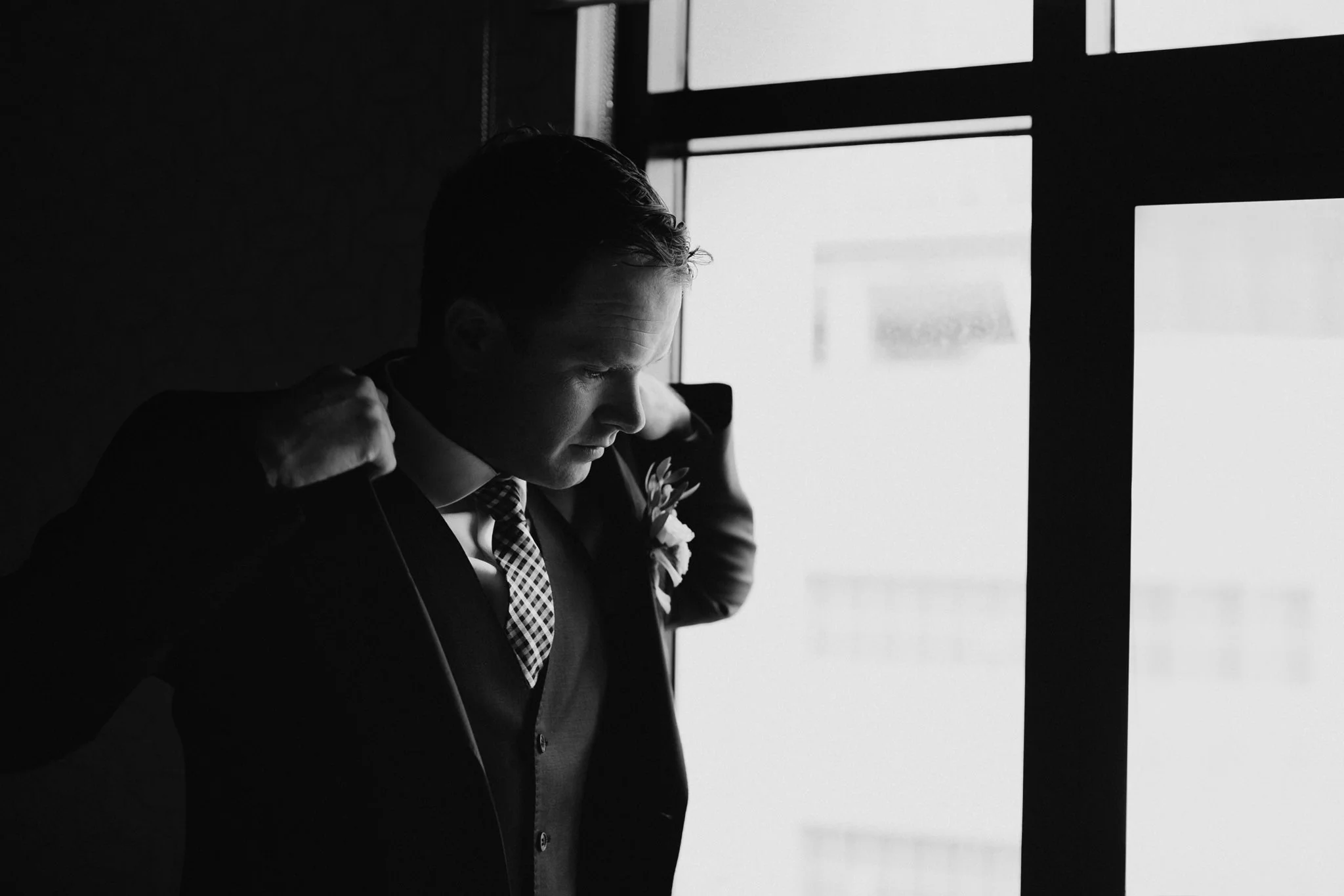 Groom looking out a window