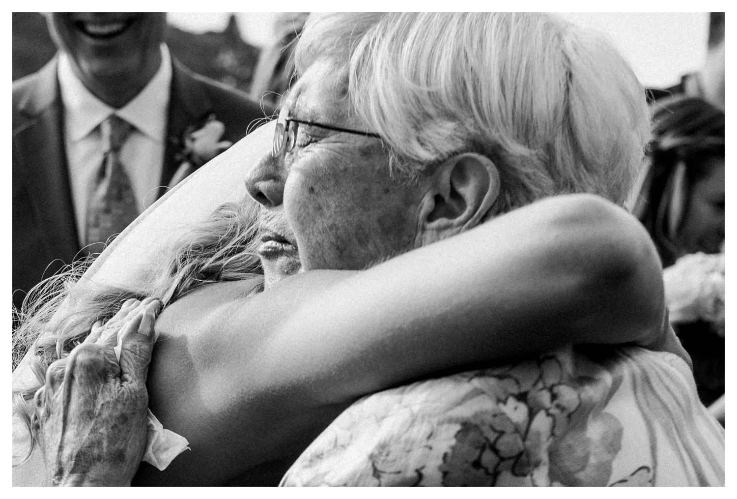 A bride hugs her grandmother during her wedding ceremony.