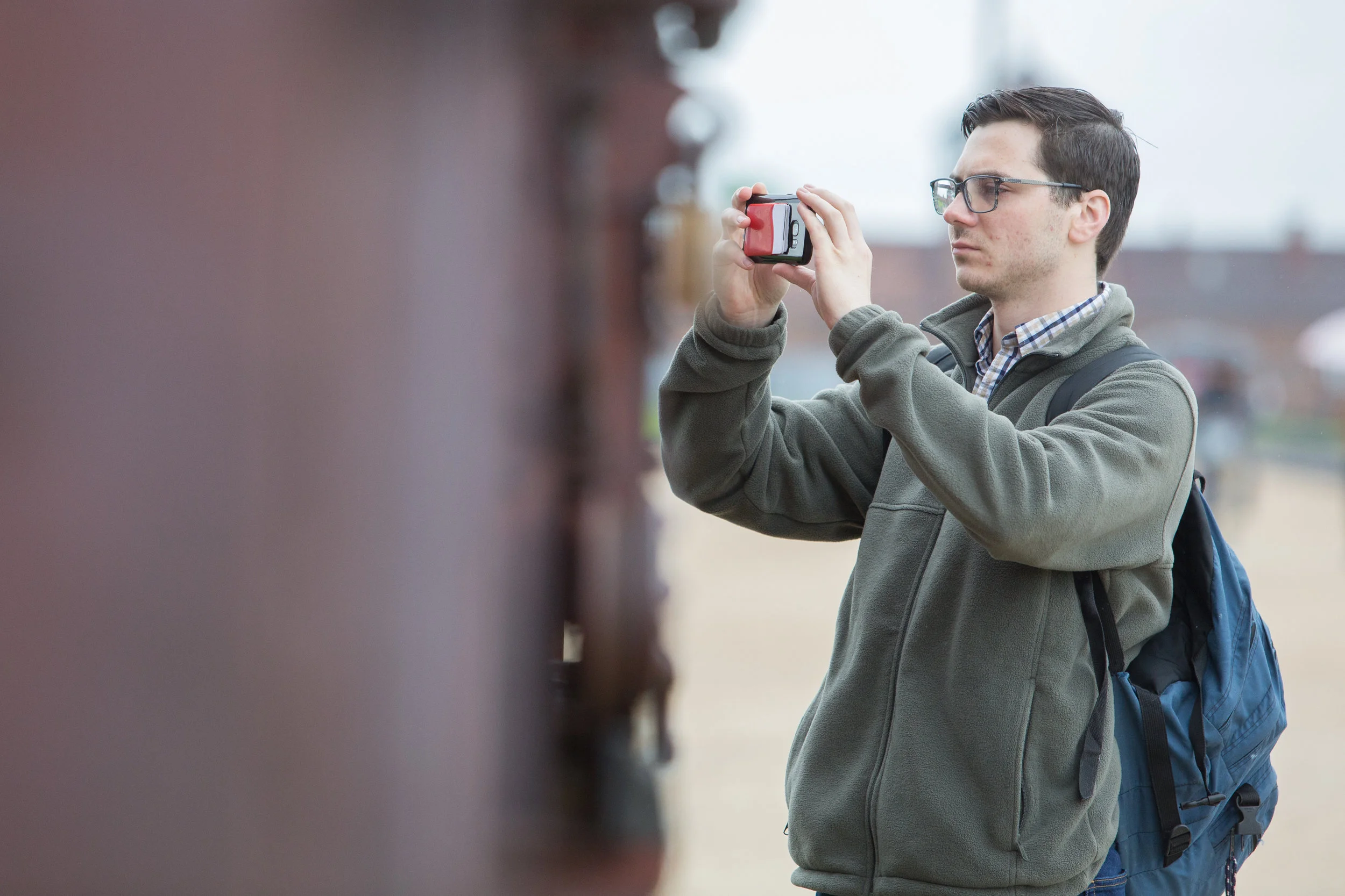 Michael Meagher photographs the boxcar at Auschwitz II - Birkenau on May 30, 2019.