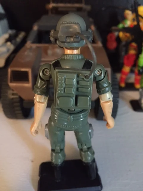 Breakers head set and microphone plug into the radio backpack which attaches to the peg hole on his back.