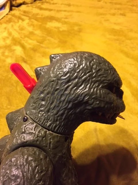 Godzilla with the new handle. You can see one of the four small screws which holds his head together just below the lever.