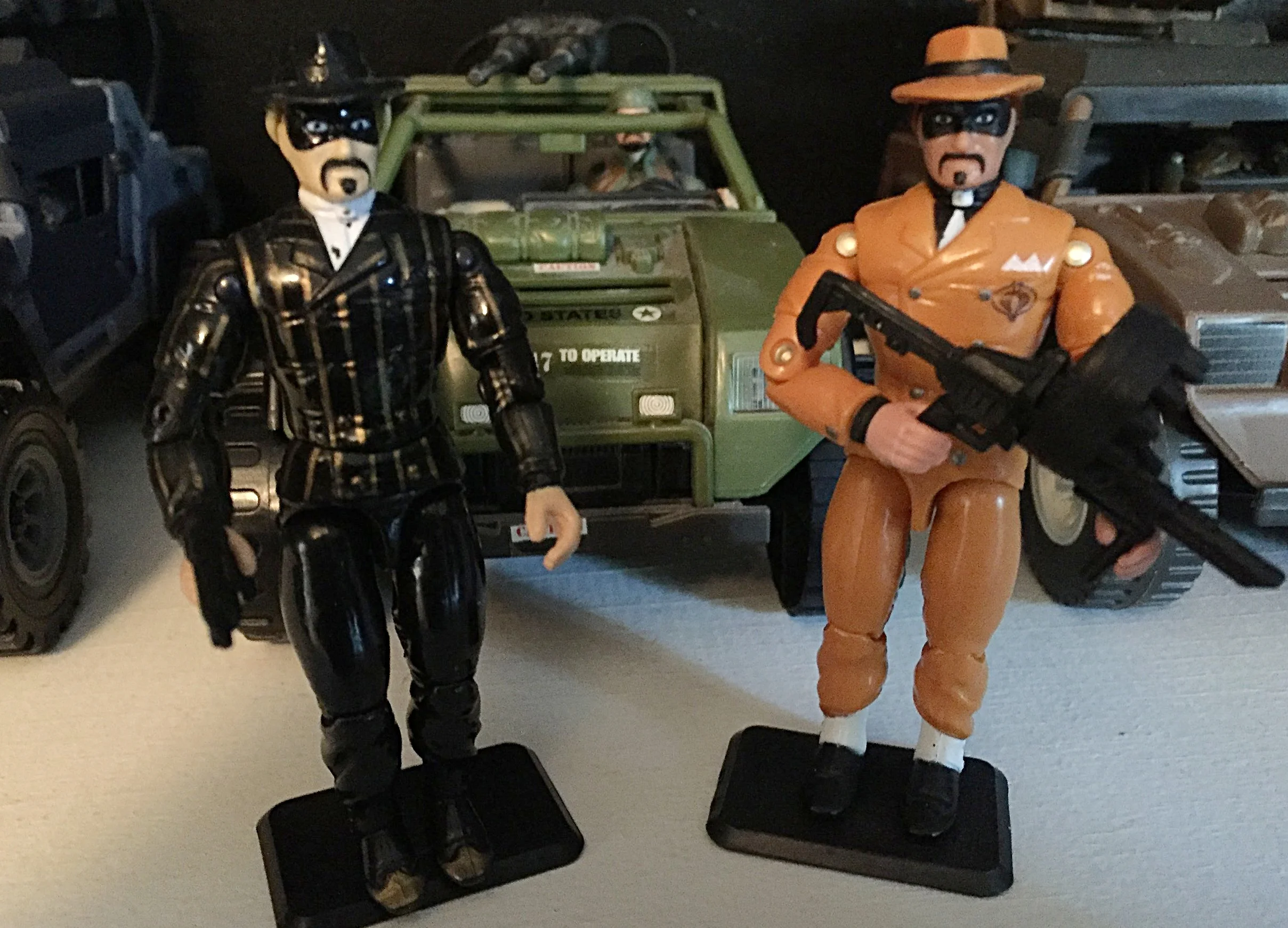 The original headman from 1992 (left) and later (2002) yellow suit version (right).