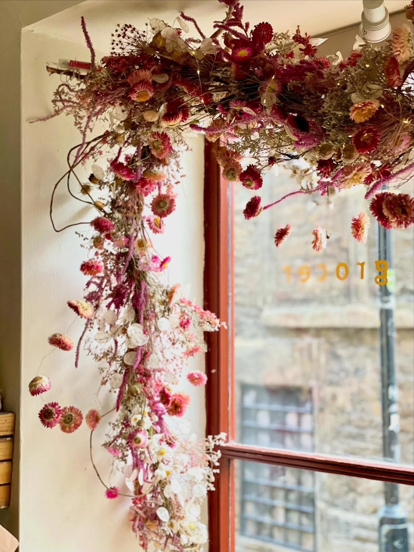 Colourful dried flower garlands adorned with helichrysum tinsel installed @oakrestaurantbath. And as a continuous staircase arrangement @hollowaysbath using flowers grown by us without the use of chemicals, bleaches and dyes. 

#somerset #somersetflo
