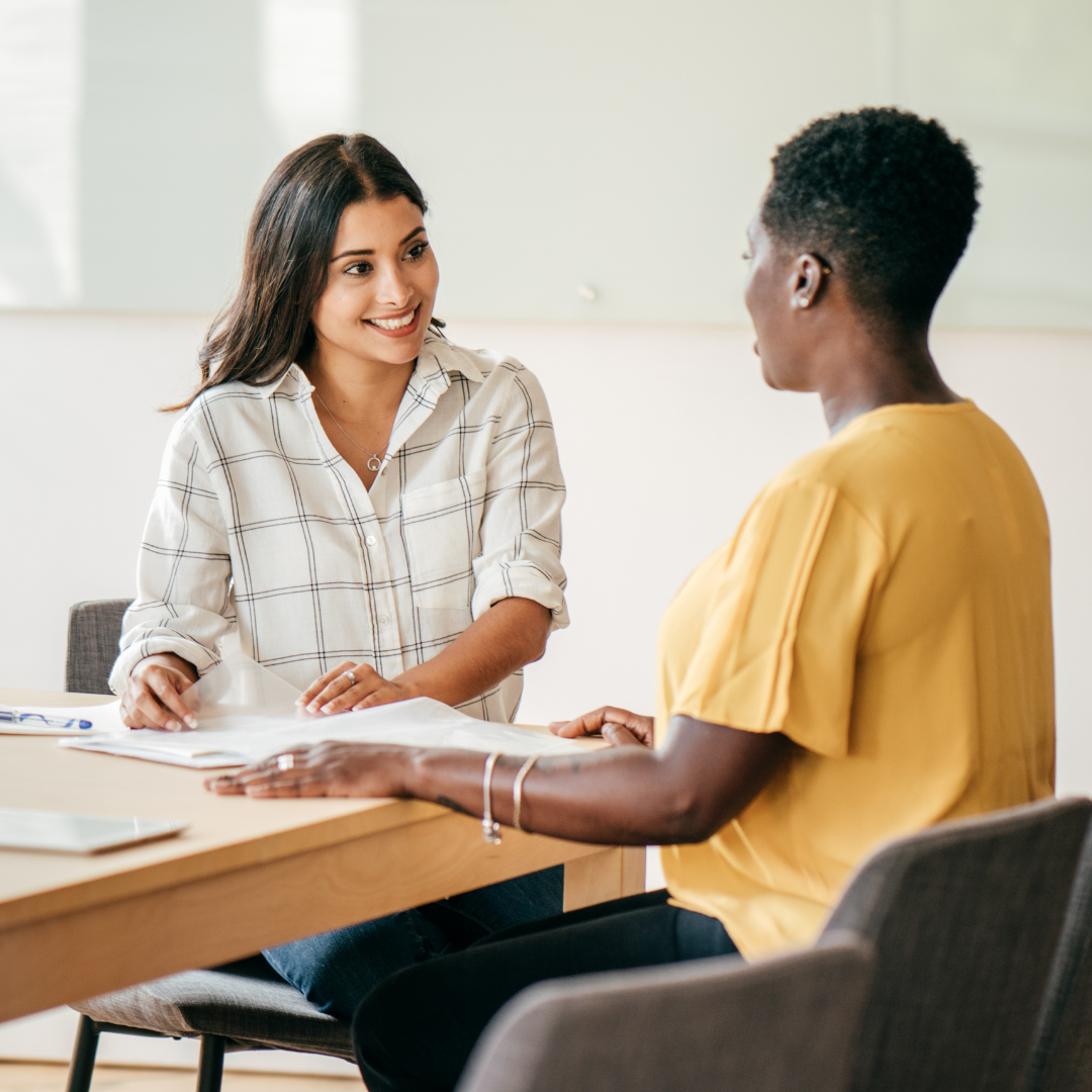 Two colleagues reviewing a resume and cover letter together
