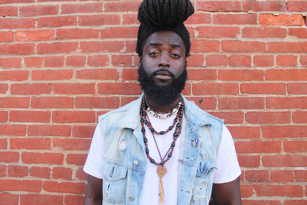 esse Piggott, 23, killing the locs pompadour game at the Odunde Festival on South Street in Philadelphia, Pa. on Sunday June 12, 2016. Photography by Sofiya Ballin.