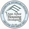 Image is a logo with an outline of three rooftops inside a circle with text reading, "Ann Arbor Housing Development." Ringing around the circle is additional text reading, "Partners for Affordable Housing Greater Ann Arbor Area."