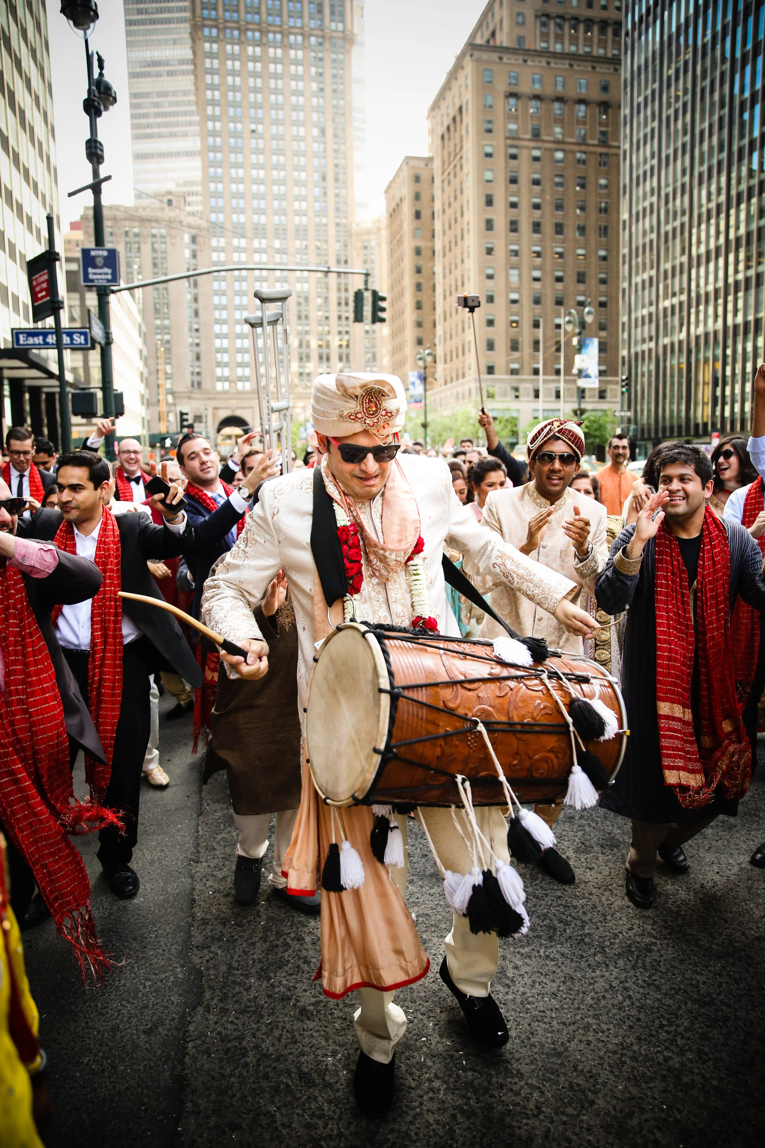 Groom playing dohl at baraat