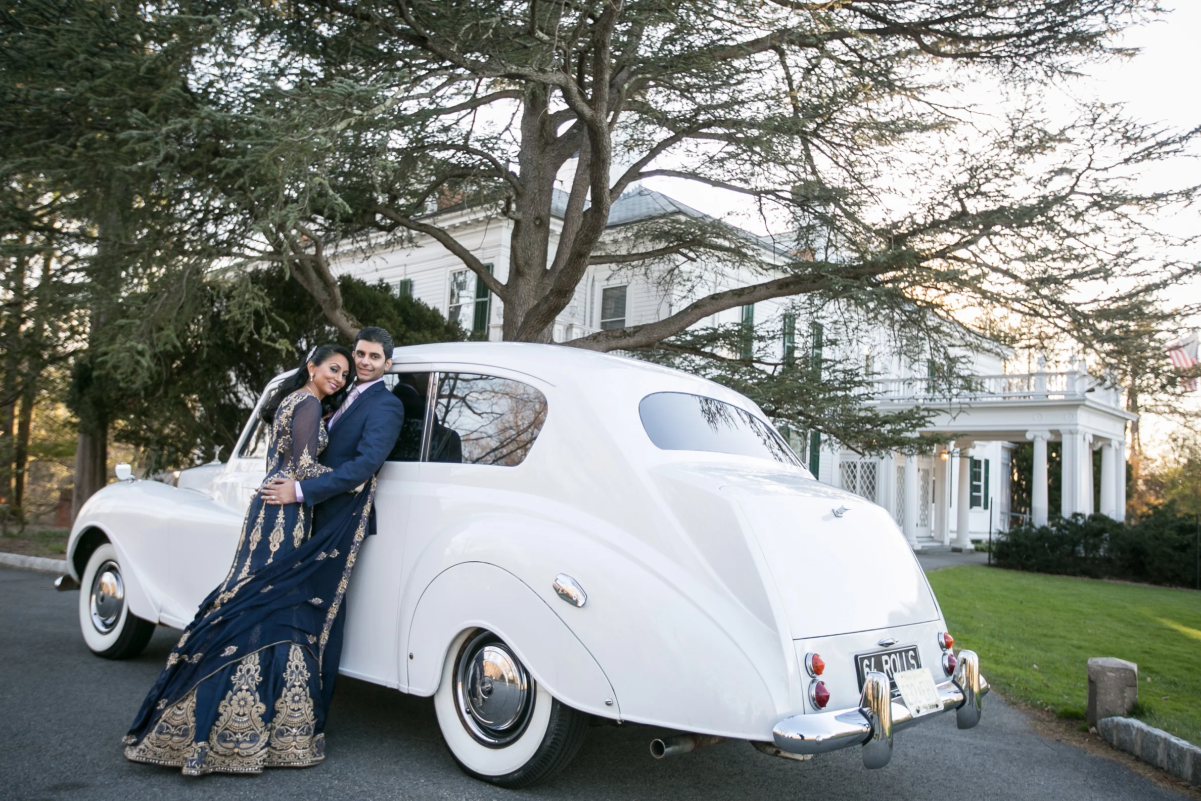 BRIDE AND GROOM ON VINTAGE CAR