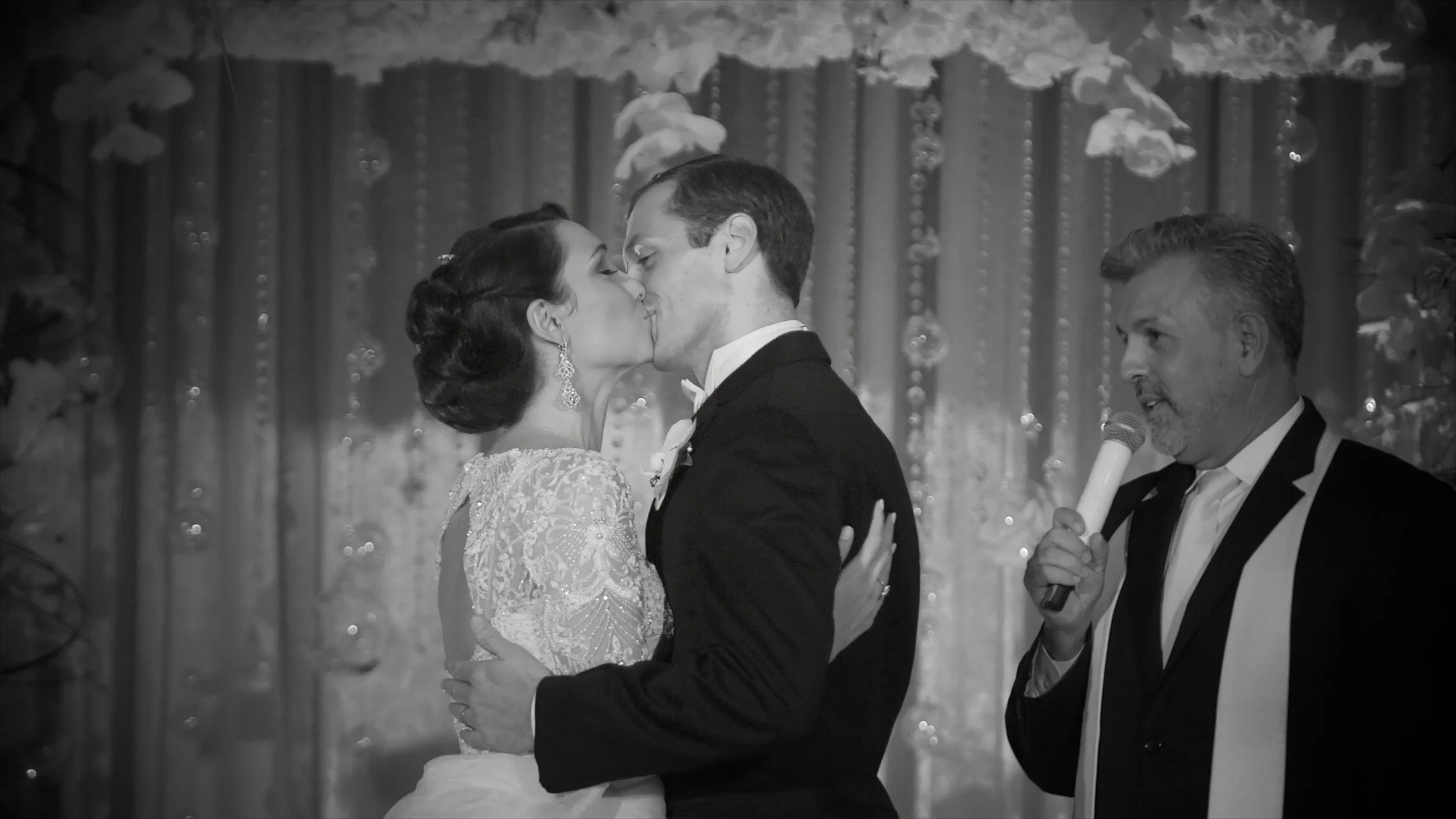 Bride and groom share their first kiss during their wedding ceremony at The Plaza Hotel in New York.
