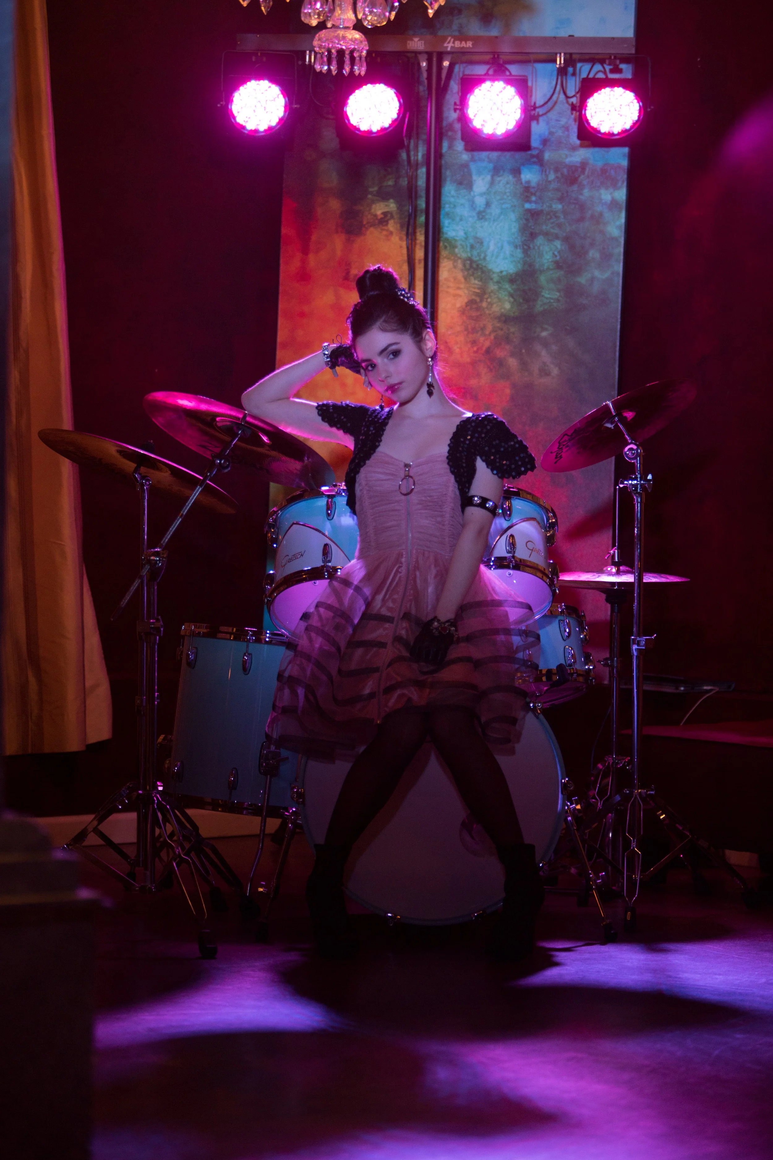 A theatrical fashion portrait built around stage lighting, color and environment, transforming the location into part of the visual story.