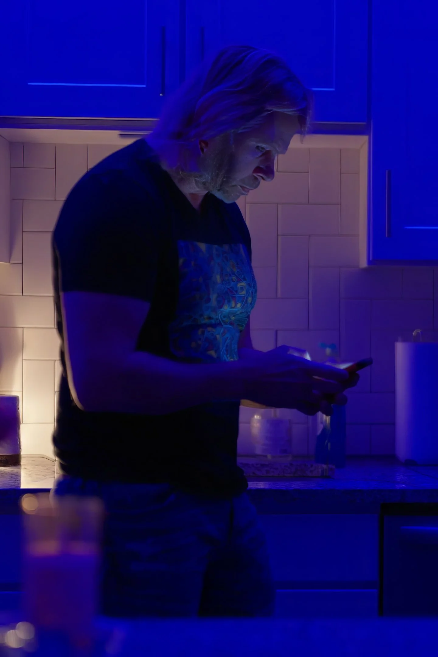 Charles Maring looking at his phone while reflecting on social media, attention, and building lasting authority beyond the feed.